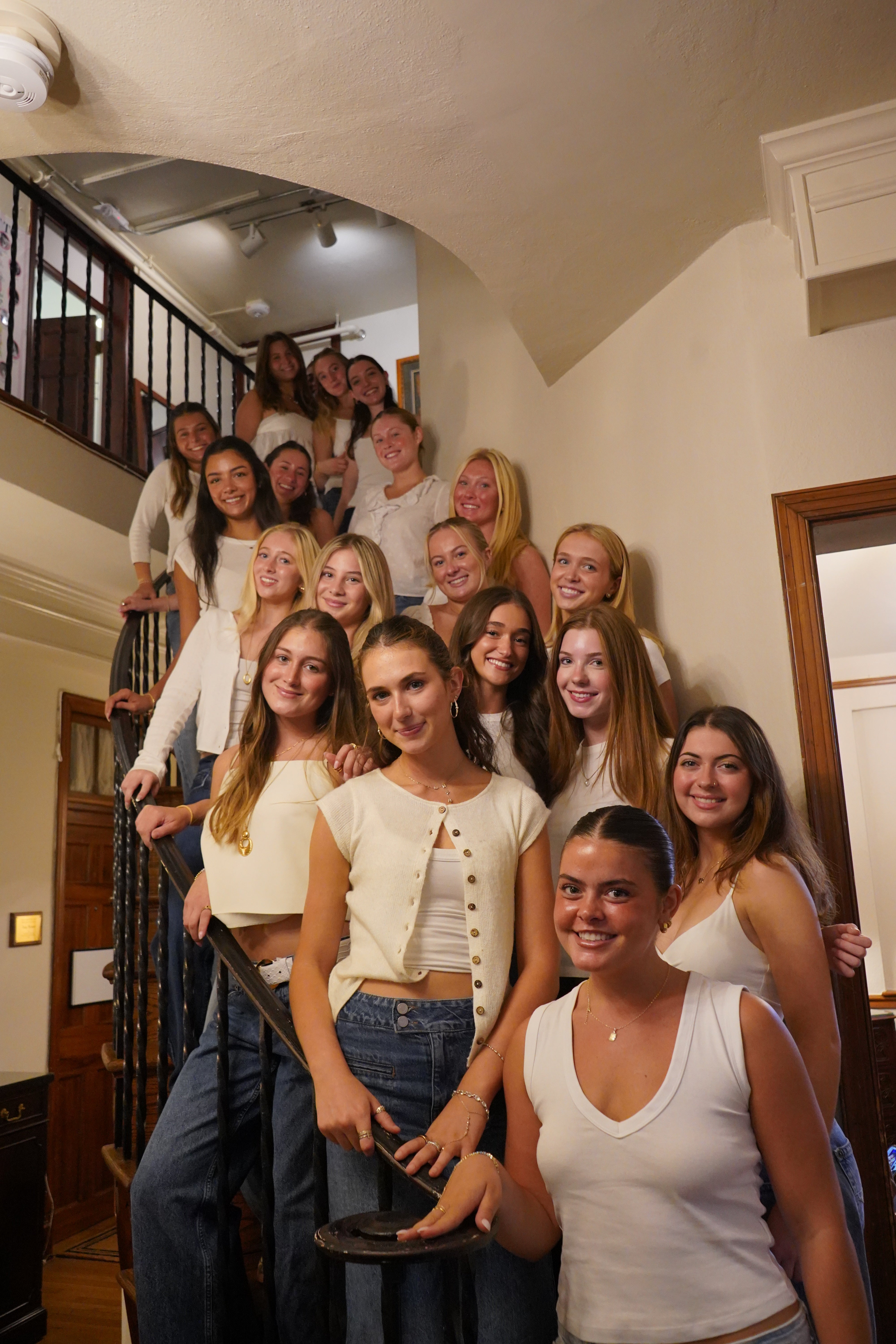Smiling women standing on stairs