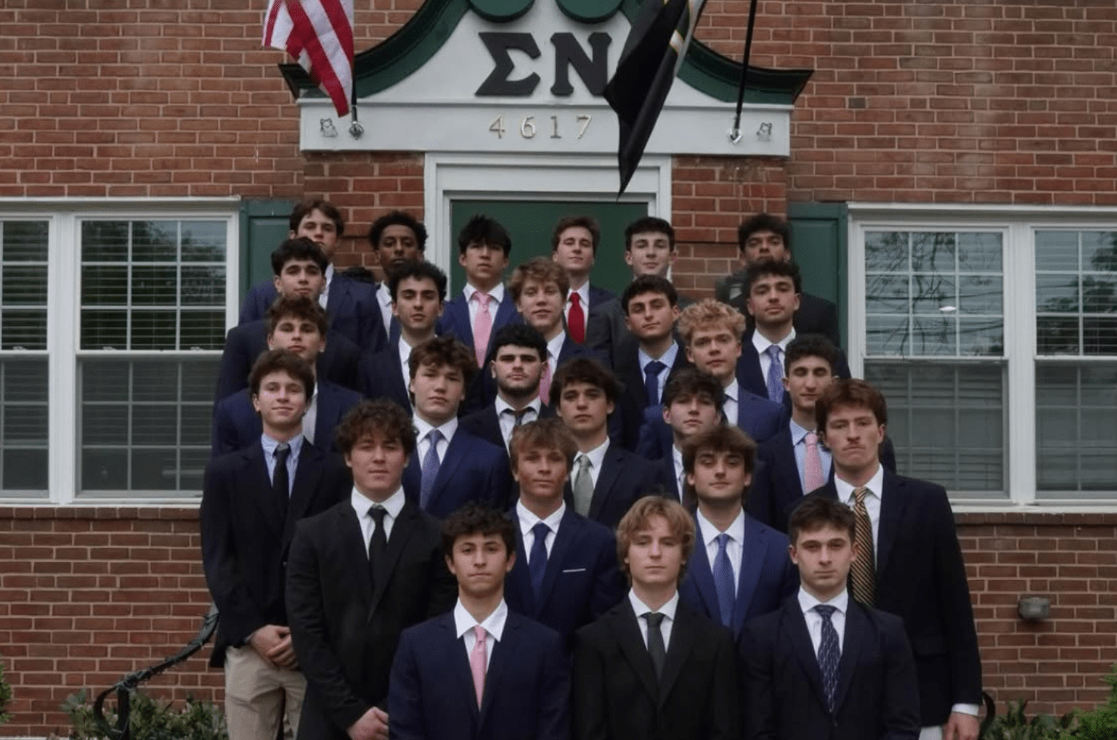 New Members of Sigma Nu in front on Sigma Nu chapter house