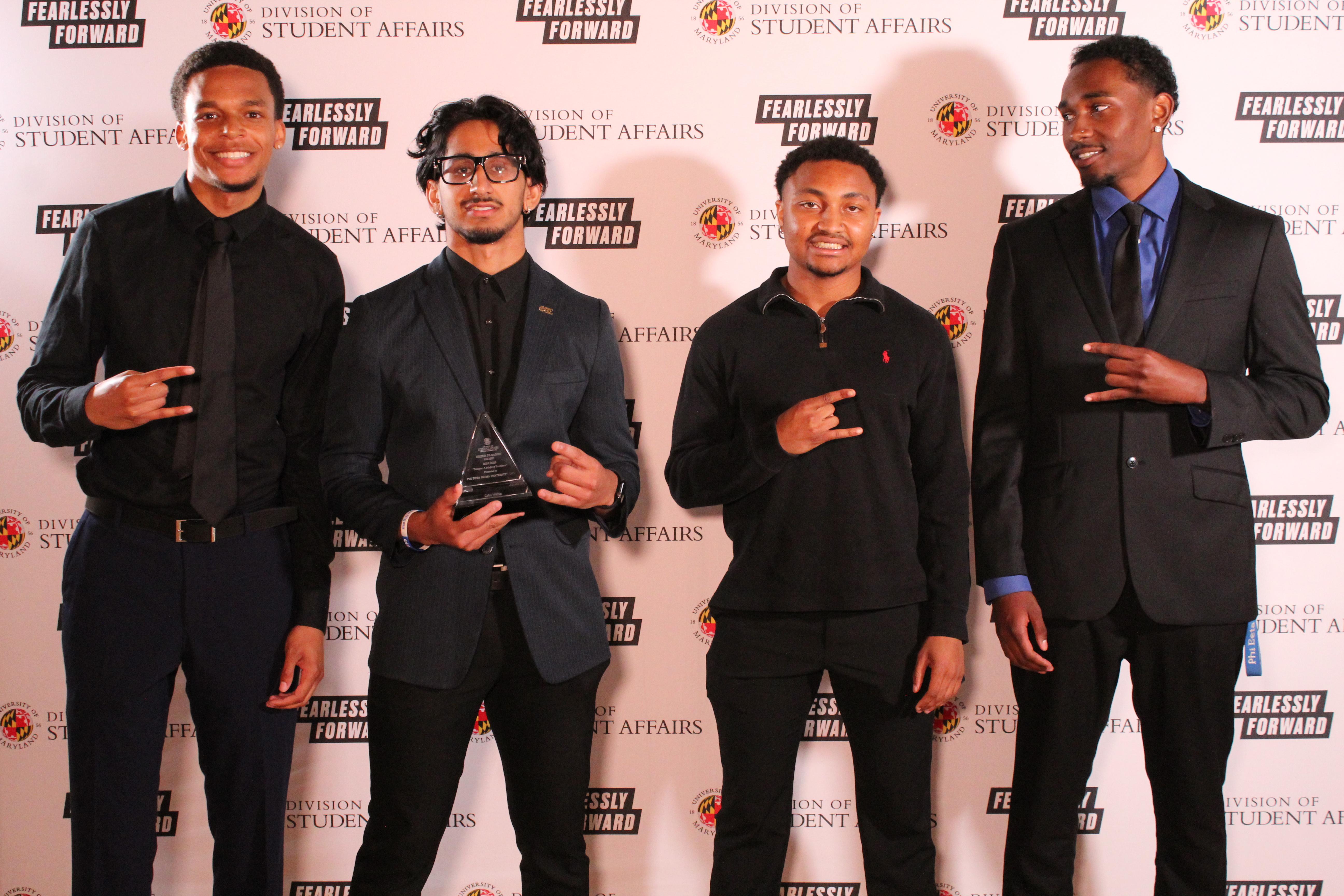 Members of Phi Beta Sigma Fraternity, Inc. with award