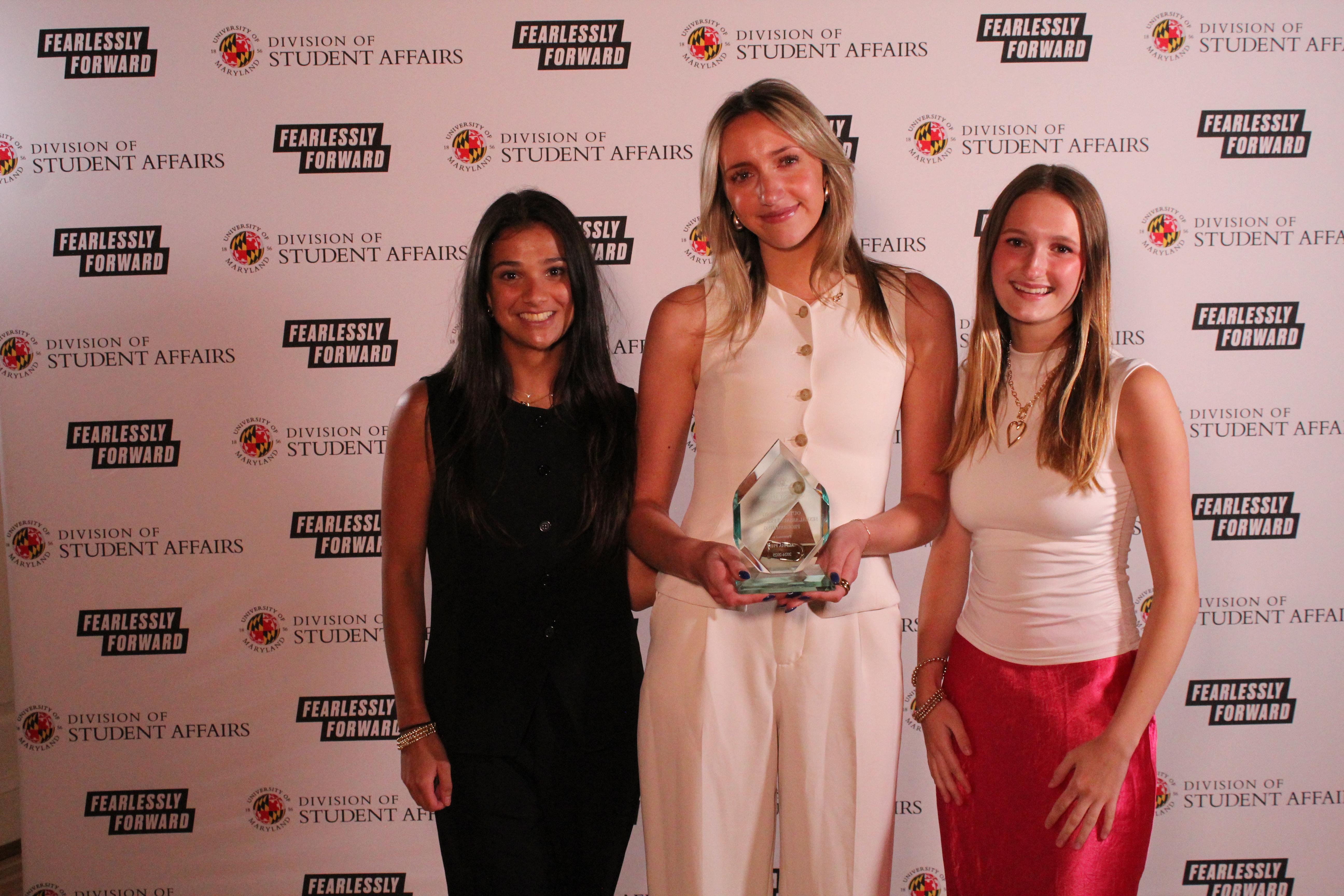 Members of Alpha Phi with an award