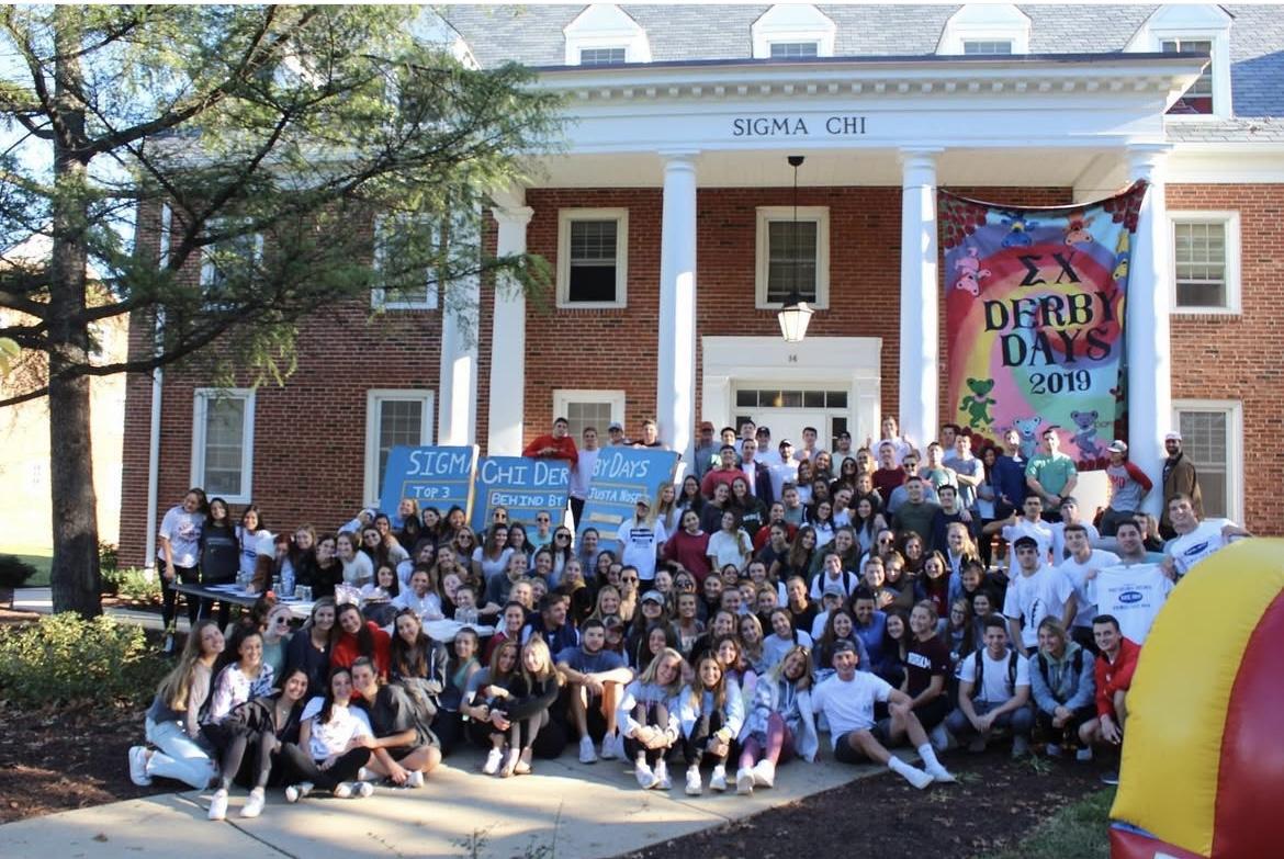 Photo of fraternity and sorority members in front of the Sigma Chi chapter house