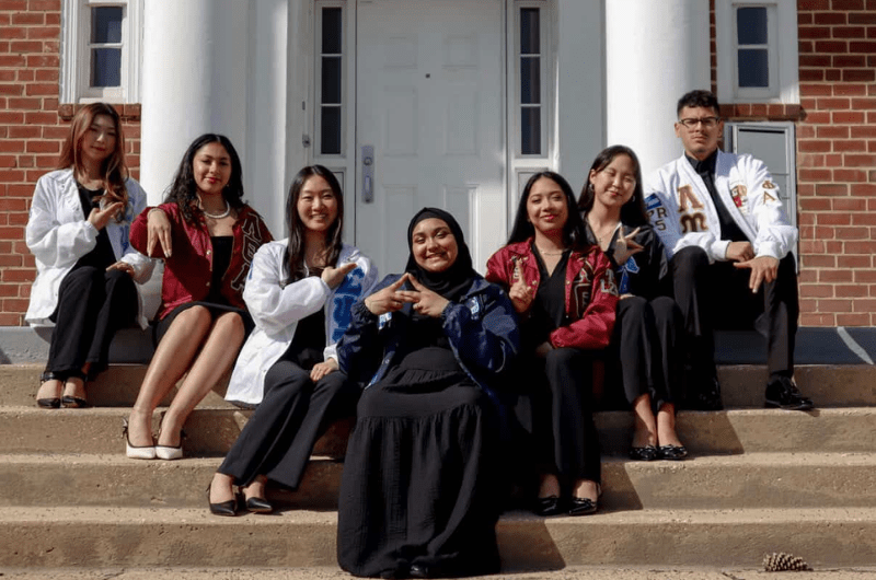 Men and women sitting on steps