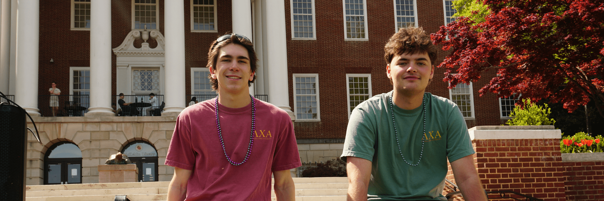 2 men sitting in front of McKeldin Library